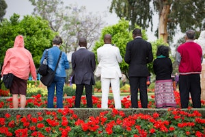 Delegates offer prayers in the gardens