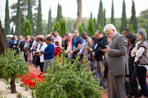 Delegates pray in the gardens