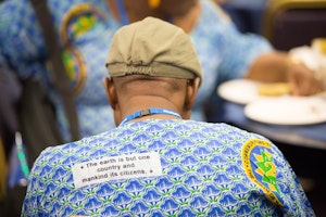 A delegate wears an outfit made from a West African cloth