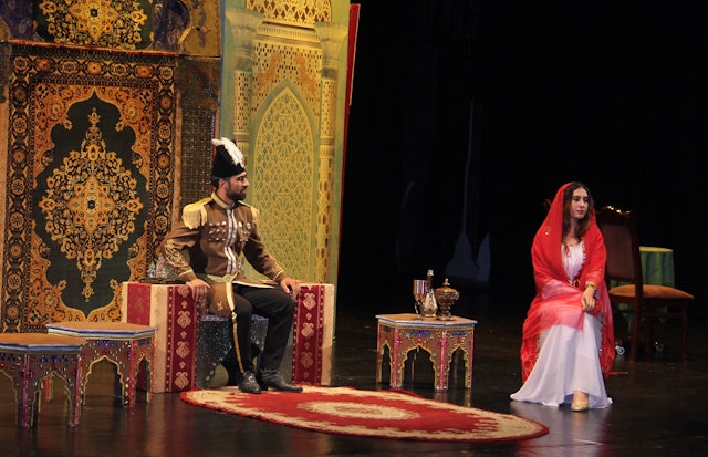 This scene from the play Daughter of the Sun depicts when Nasiri’d-Din Shah, the king of Persia, met with Tahirih, offering to marry her if she recanted her faith. Tahirih turned down the offer with poetry: “Kingdom, wealth, and power for thee / Beggary, exile, and loss for me / If the former be good, it’s thine / If the latter is hard, it’s mine.”